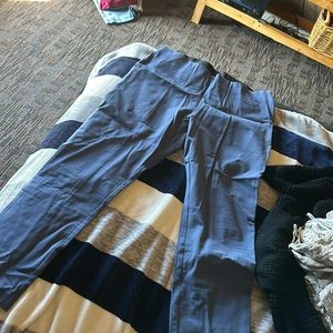 Navy blue pixie work pants with a side zipper about ankle length.